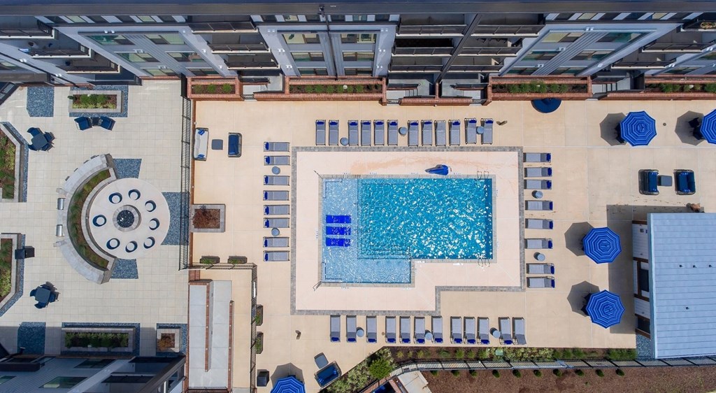 a rendering of the pool area of a hotel with a large swimming pool