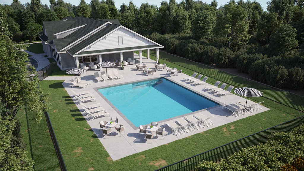 a yard with a swimming pool and patio furniture in front of a house