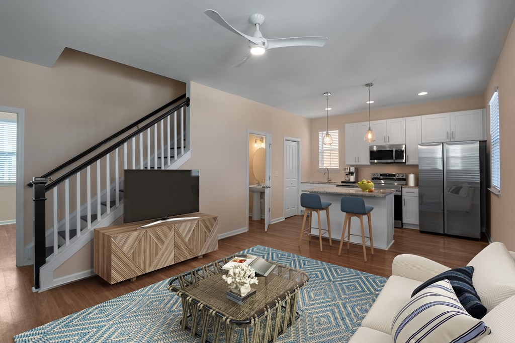 A living room with a staircase and a television.
