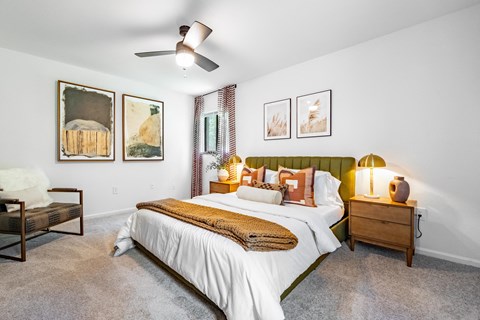 a bedroom with a bed and a ceiling fan