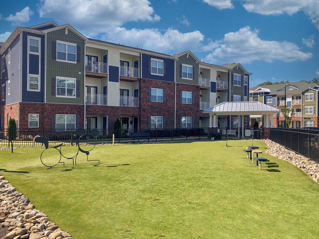 an apartment building with a tennis court in front of it