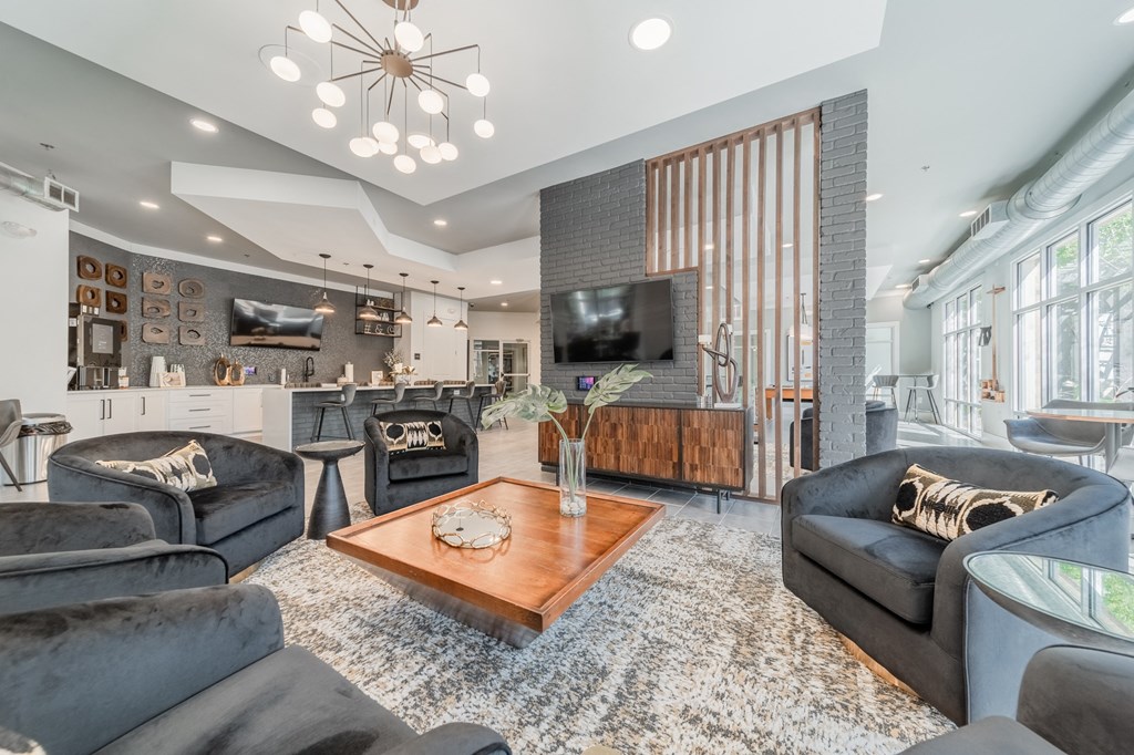 a living room filled with furniture and a large window