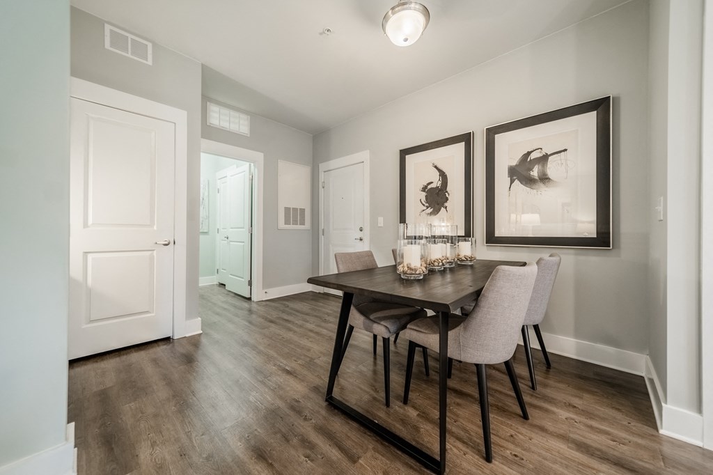 an open living room and dining room with a table and chairs