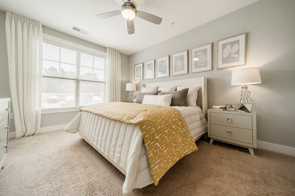 a bedroom with a bed and a ceiling fan