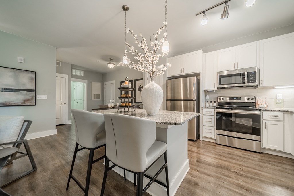 a kitchen with stainless steel appliances and a marble counter top