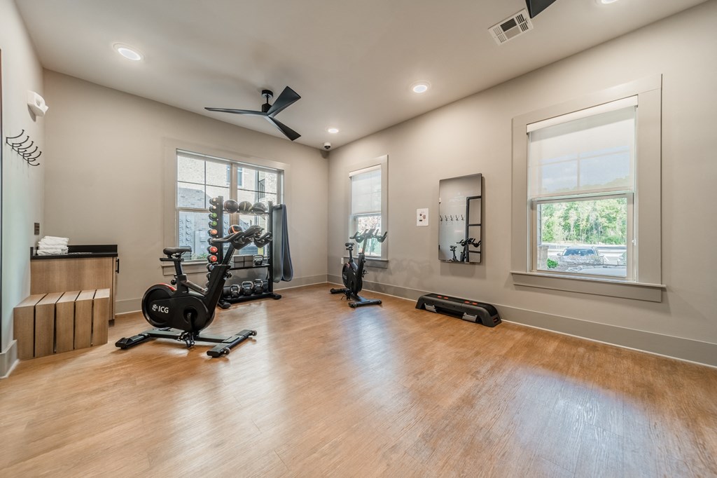 a home gym with exercise equipment and windows