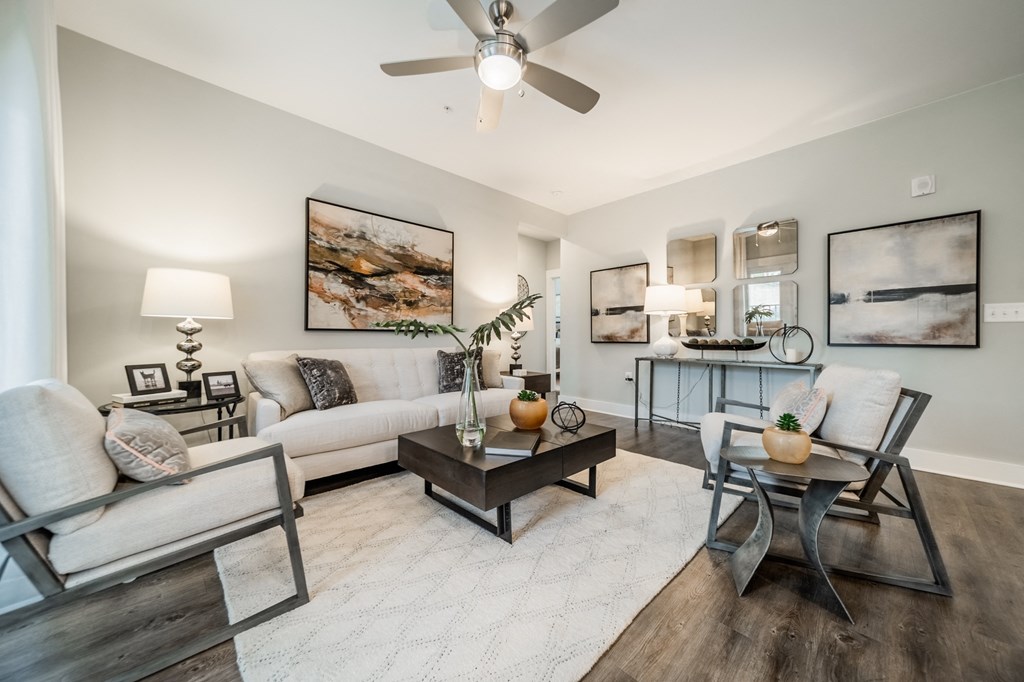 a living room with couches and chairs and a table