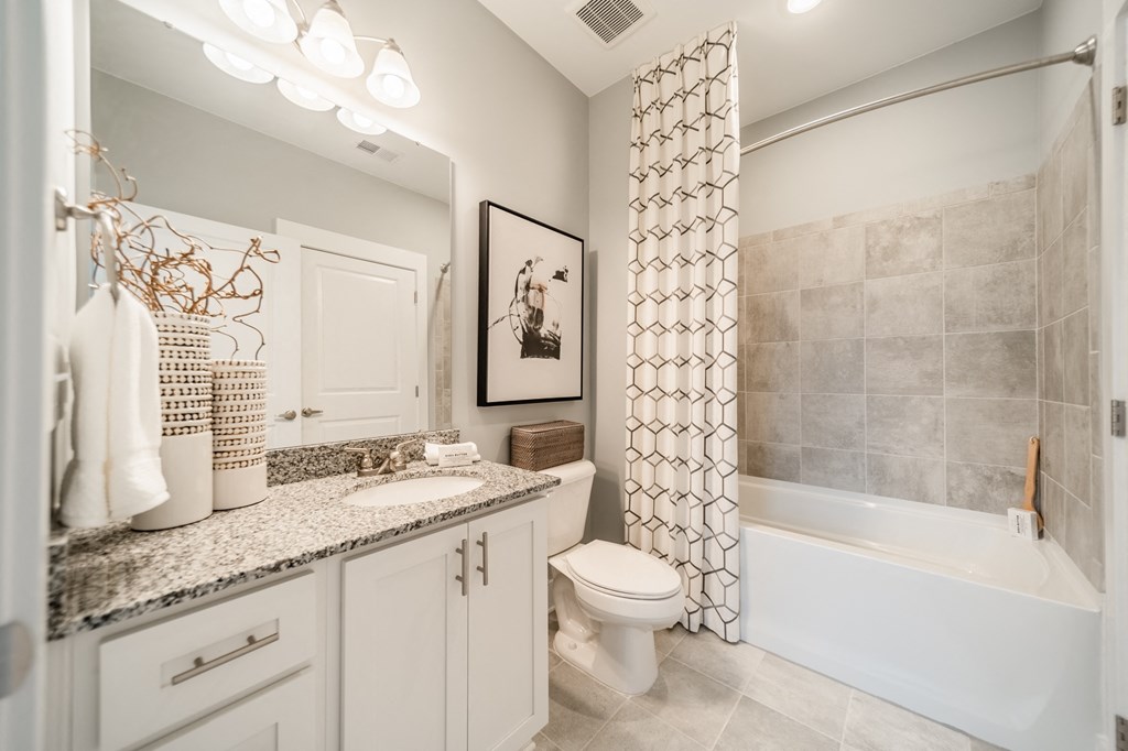 a bathroom with a toilet and a tub and a sink