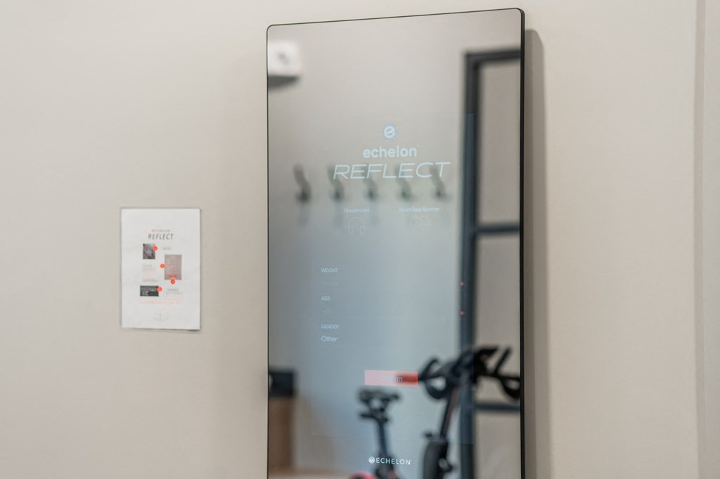 a mirror with a reflection of a bike in front of a door