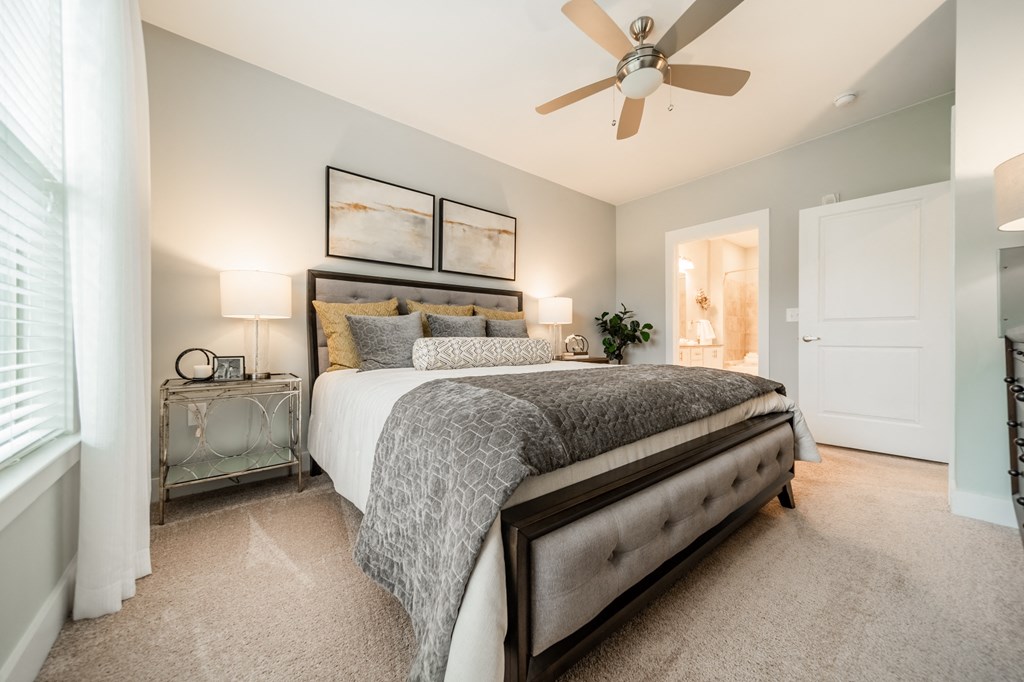 a bedroom with a bed and a ceiling fan