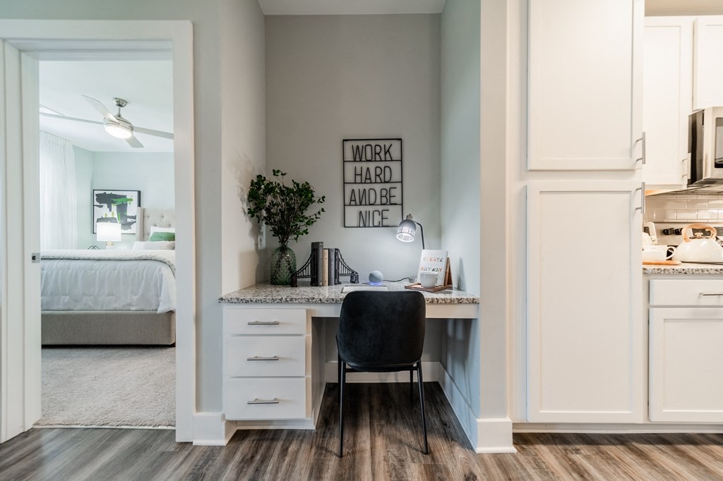 a home office with a desk and a chair and a bedroom