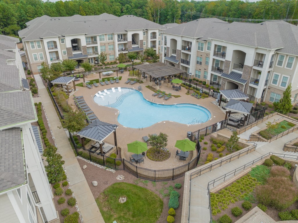 an aerial view of an apartment complex with a large swimming pool
