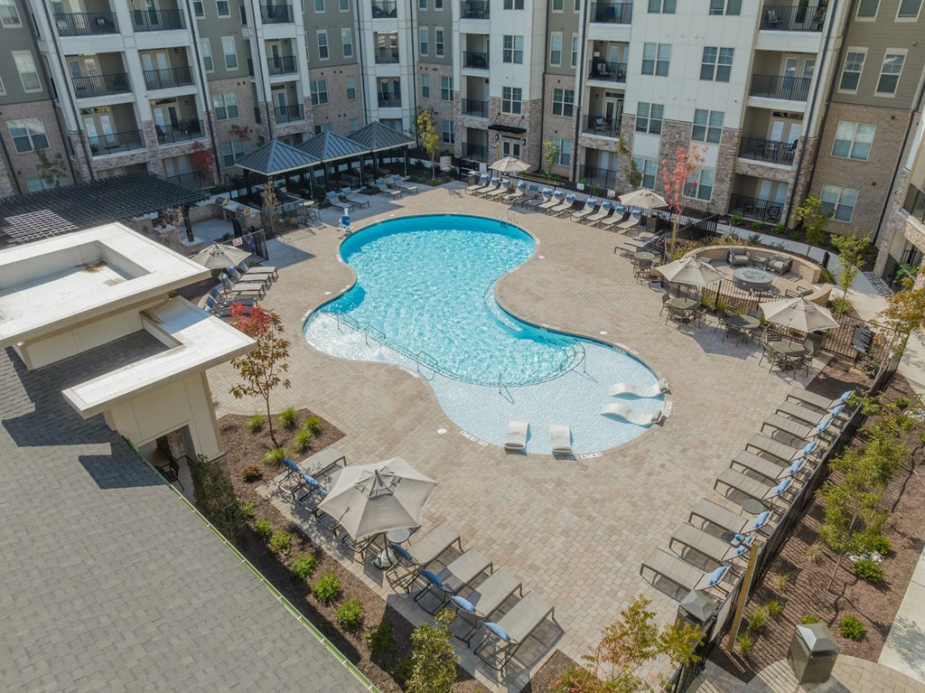 an aerial view of an apartment building with a swimming pool