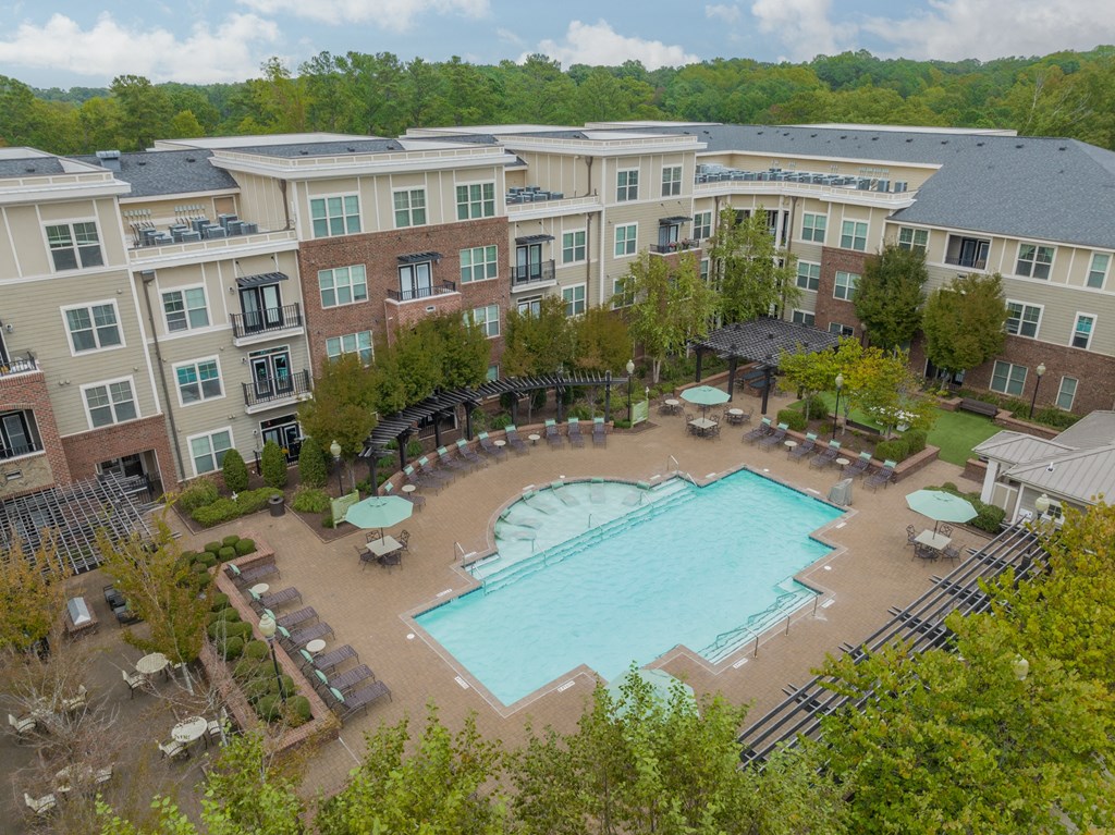an aerial view of an outdoor swimming pool and resort building