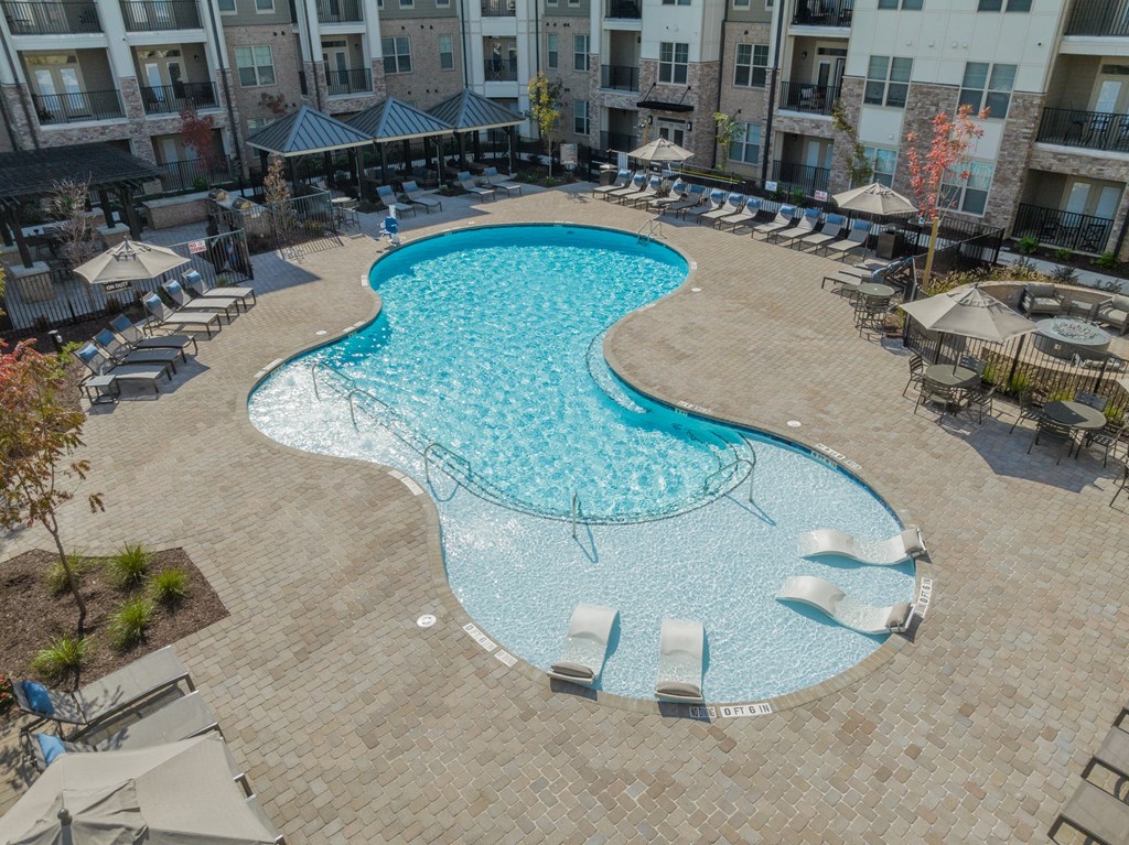 an aerial view of a swimming pool at an apartment building