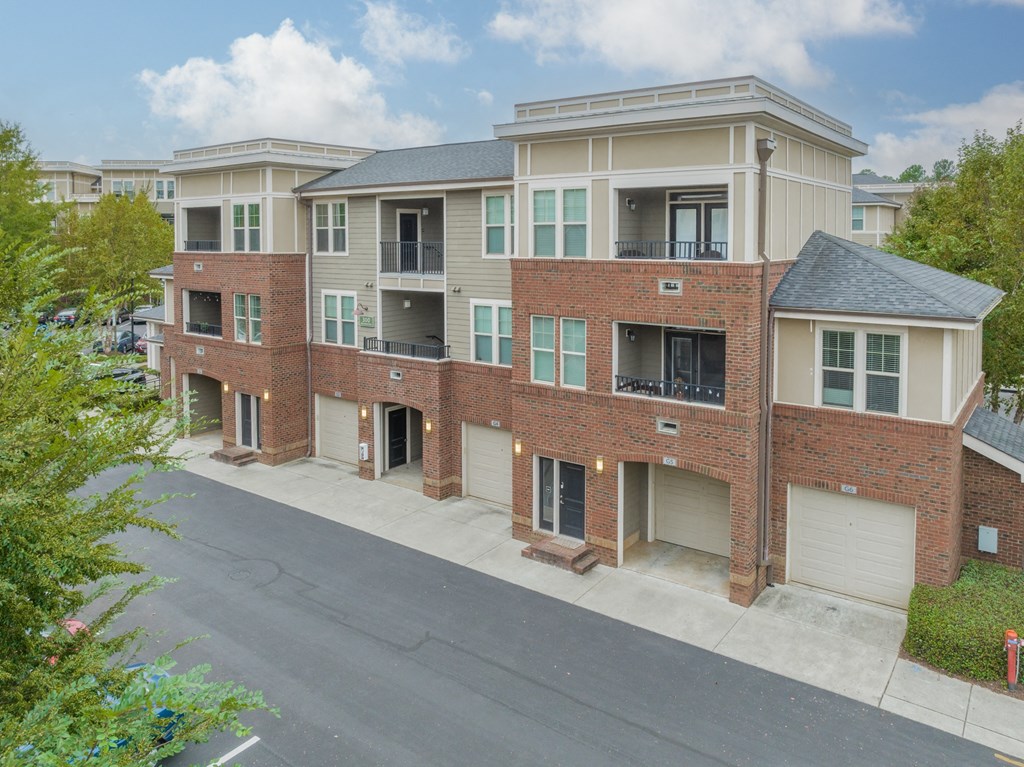 a large brick apartment building with a street in front of it