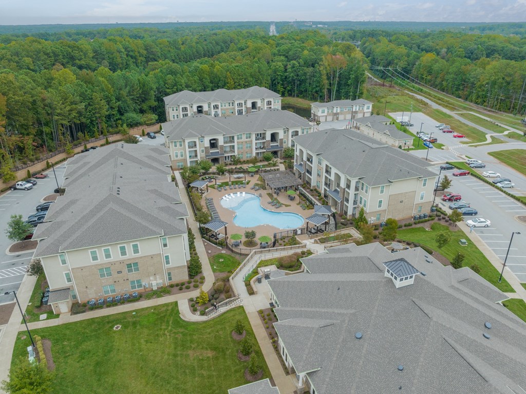 an aerial view of an apartment complex with a swimming pool