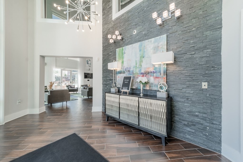 a living room with a console and a large painting on the wall