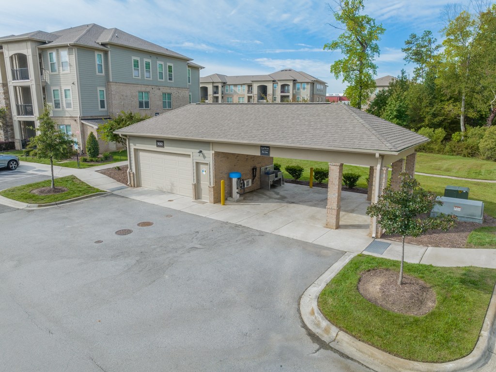 a large parking lot with a garage and a house