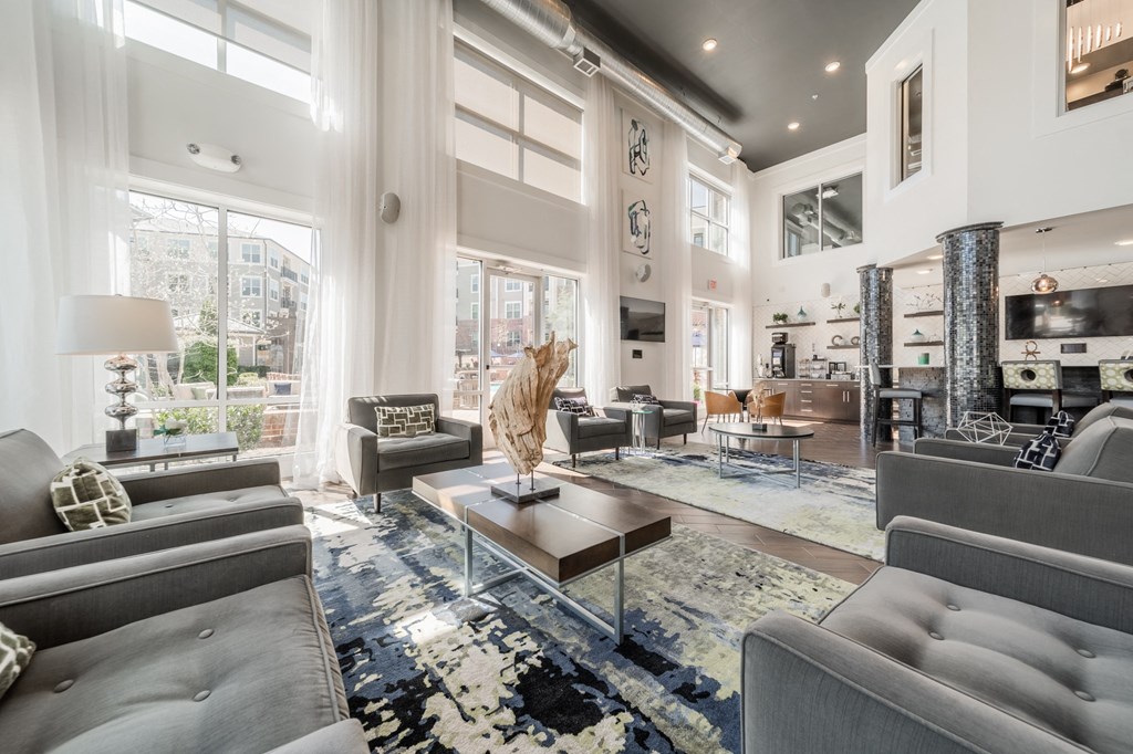 a living room filled with furniture and a large window