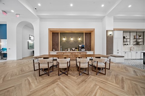 A dining room with a wooden table and chairs.