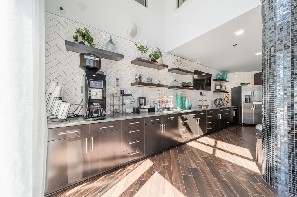 a kitchen with stainless steel appliances and a wood floor