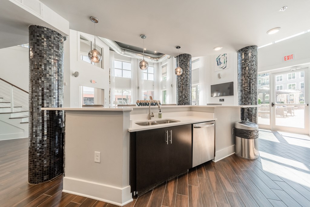 a kitchen with a large island with a sink and a dishwasher