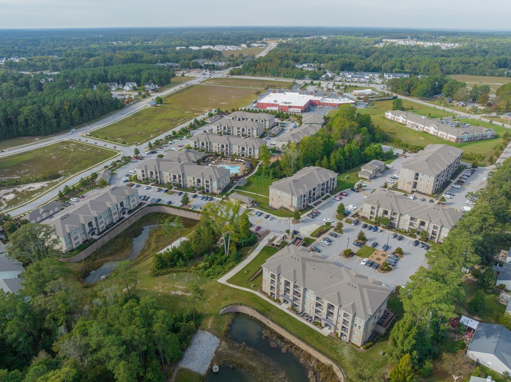 an aerial view of a city with houses and a parking lot