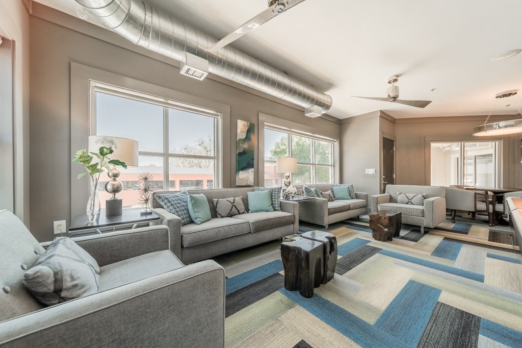 a living room filled with furniture and a large window