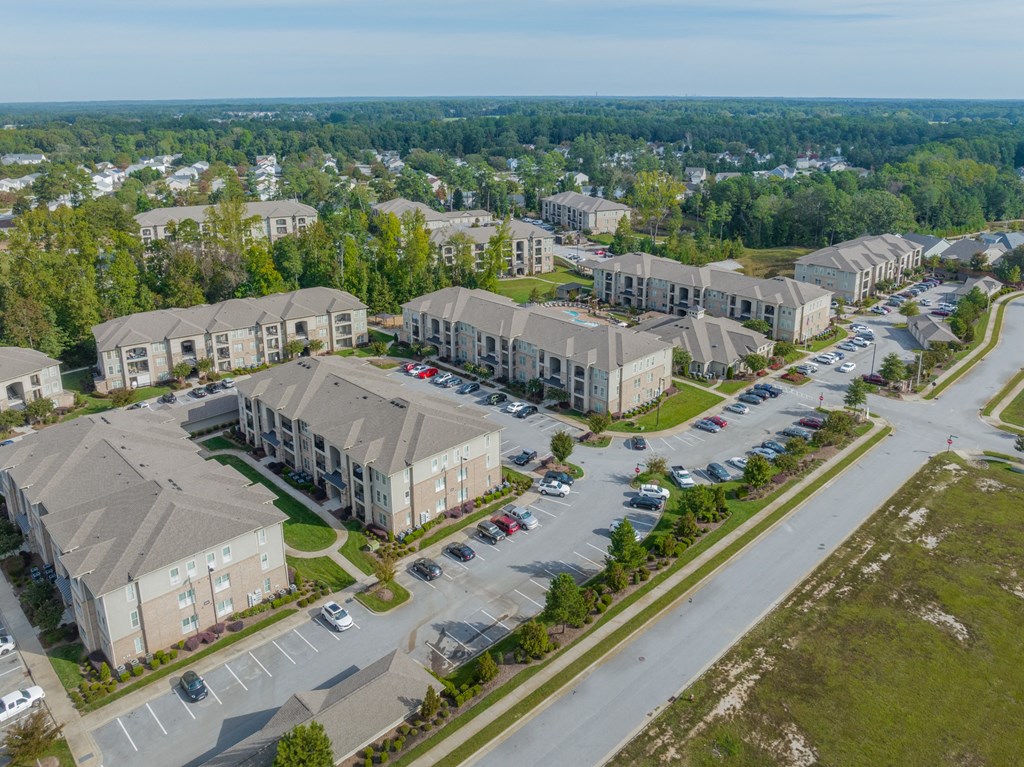 an aerial view of a group of houses in a parking lot