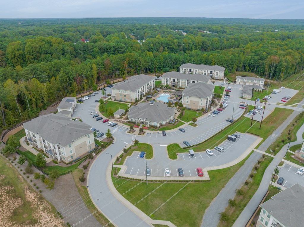 an aerial view of a community with houses and parking lot