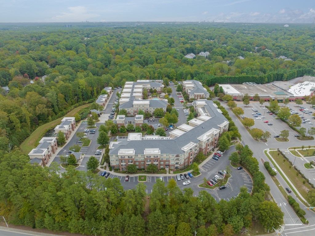 an aerial view of a parking lot and buildings in a city