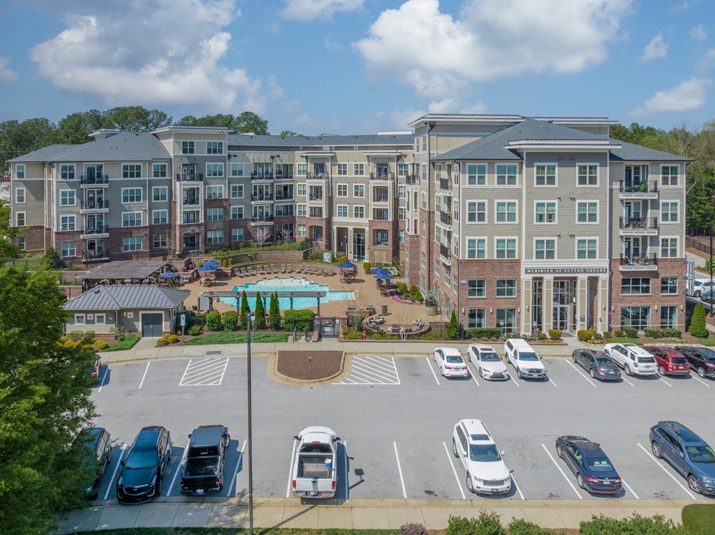 a large parking lot with a large building in the background