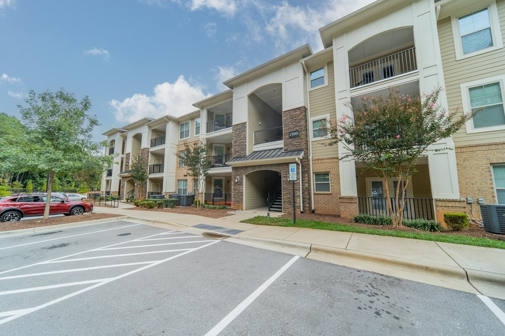 an apartment building with a parking lot and a street
