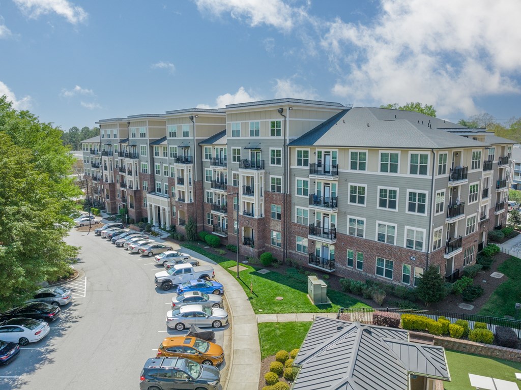 a large apartment building with a parking lot in front of it