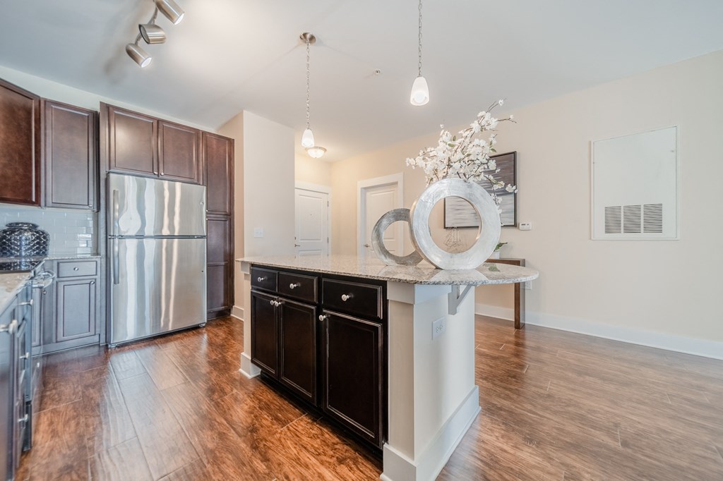 a kitchen with a large island and stainless steel appliances