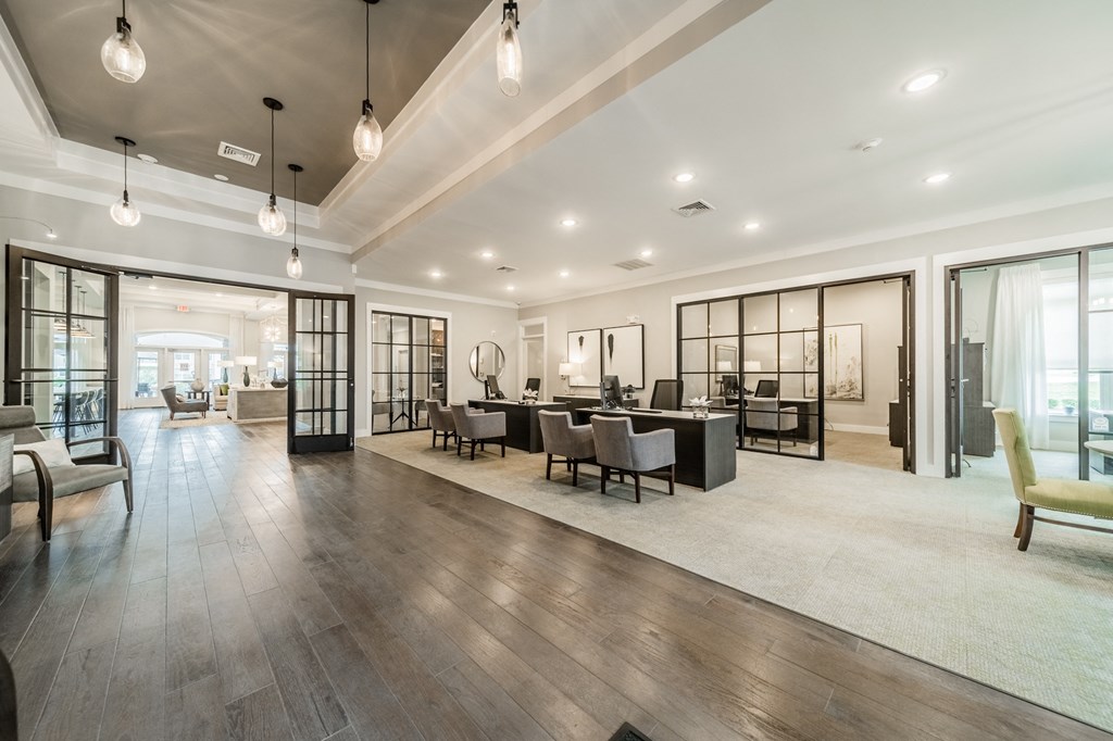 a large living room with a table and chairs in it