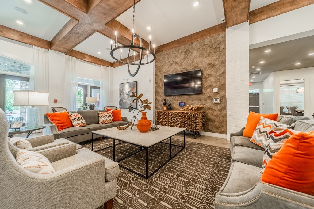 a living room with couches and chairs and a table