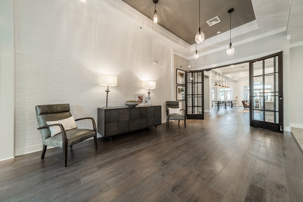 the preserve at ballantyne commons community lobby with chairs and tables and glass doors