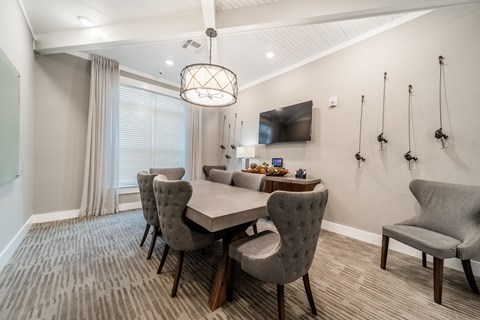 a dining room with a table and chairs and a tv