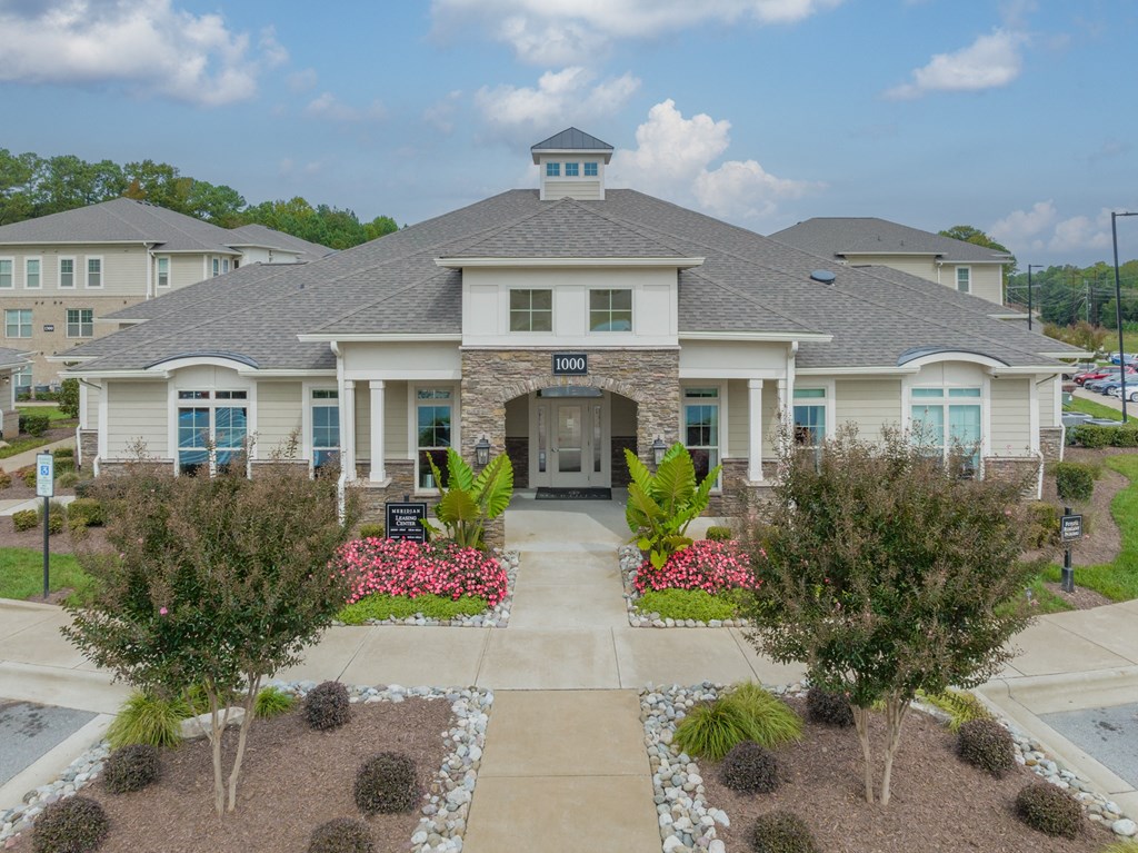 a large house with a driveway and landscaping in front of it