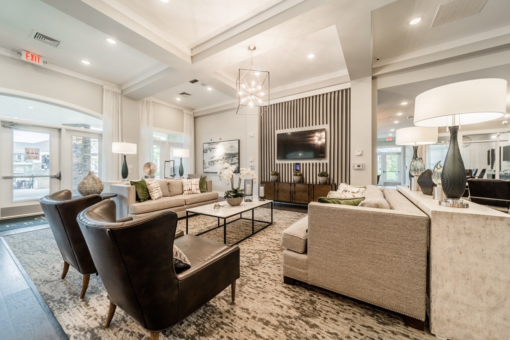 a living room with couches and chairs and a television