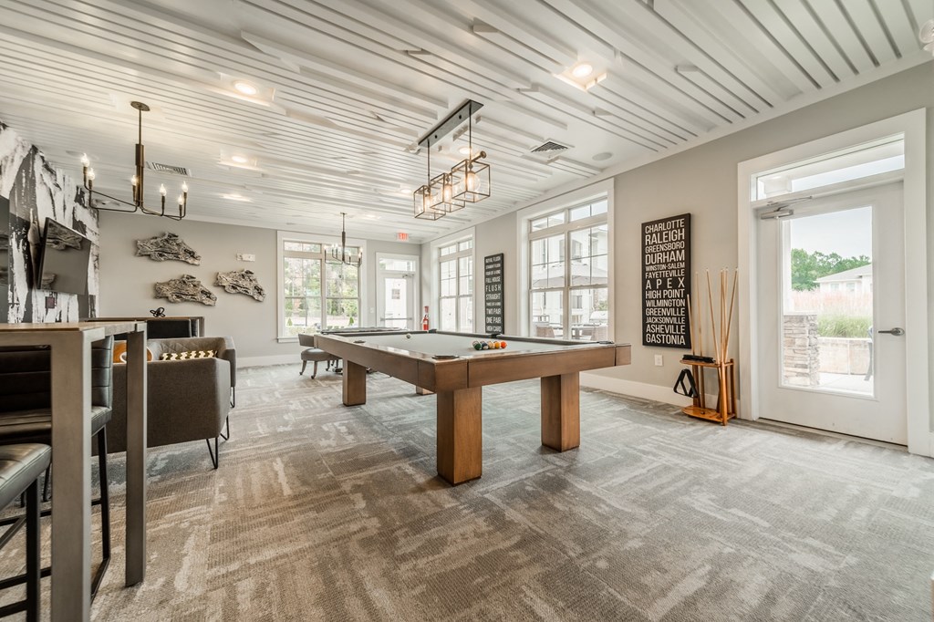 a game room with a pool table and a bar