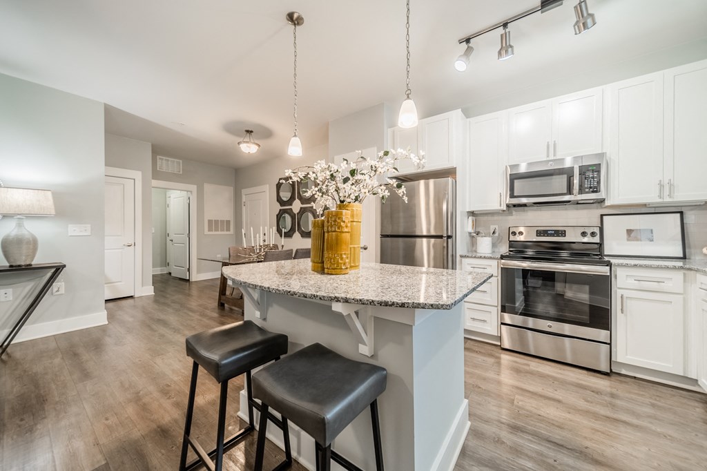 a kitchen with stainless steel appliances and a marble counter top