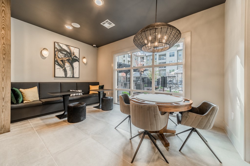 a dining room with a table and chairs and a large window