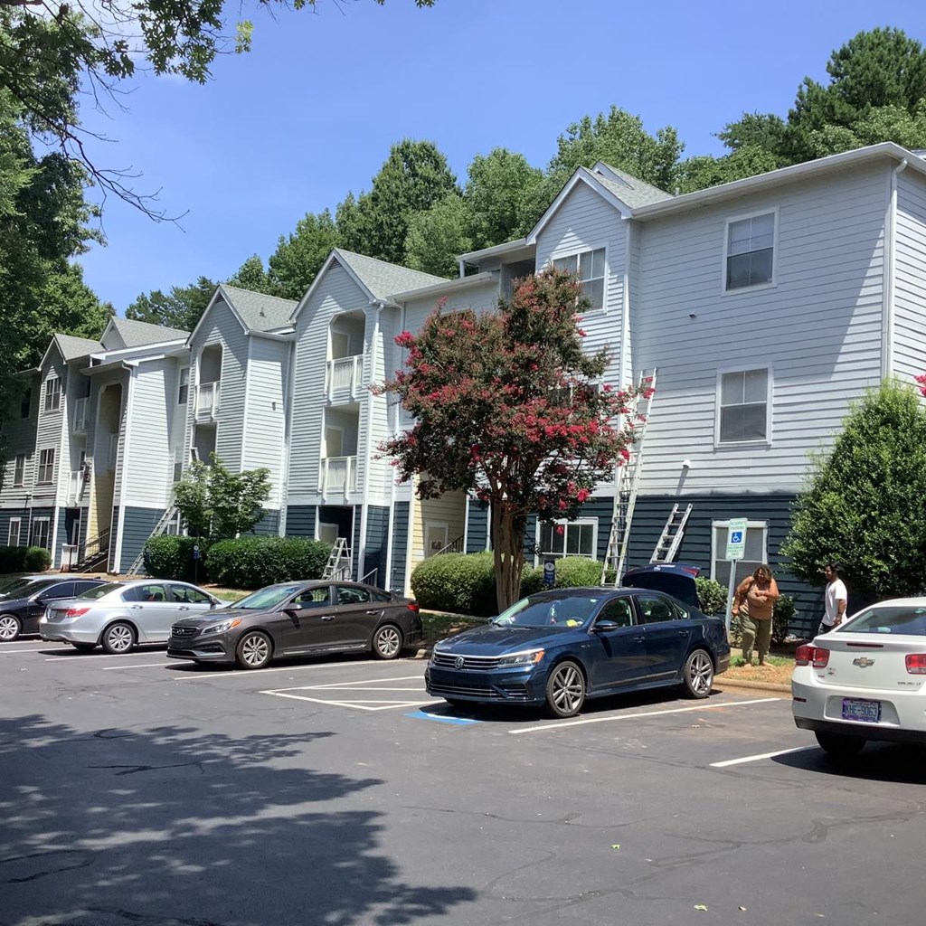 an apartment building with cars parked in front of it