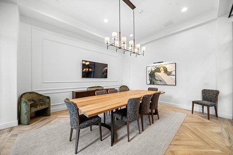 A dining room with a wooden table and chairs.