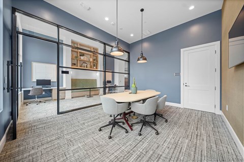 A conference room with a table and chairs.