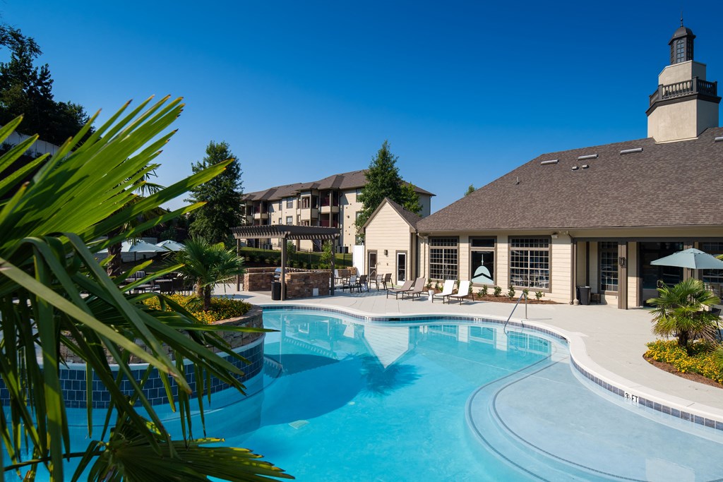 a swimming pool with a hotel in the background