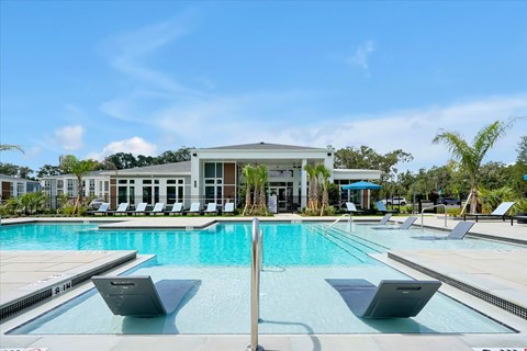 A pool with a building behind it.